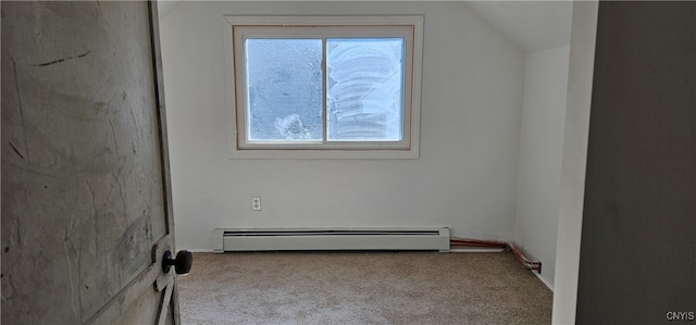 empty room featuring light colored carpet, a baseboard radiator, and a wealth of natural light