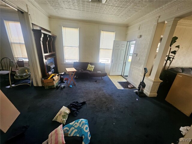 miscellaneous room featuring ornamental molding, decorative columns, plenty of natural light, and carpet