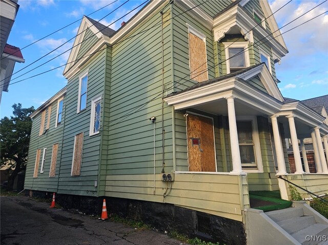 view of side of home with covered porch