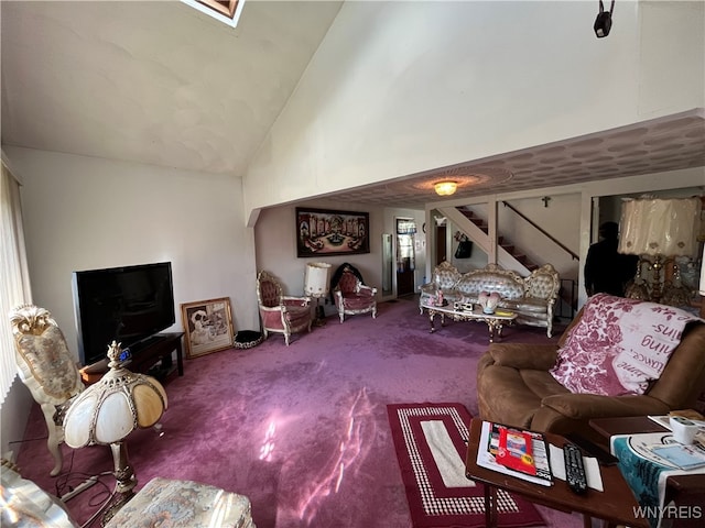 carpeted living room with high vaulted ceiling