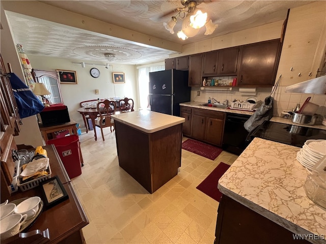 kitchen with black appliances, ceiling fan, a center island, tasteful backsplash, and a textured ceiling