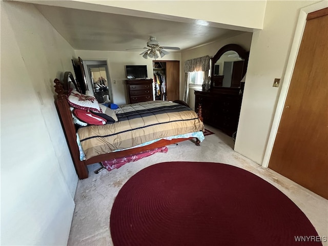 carpeted bedroom with a closet and ceiling fan