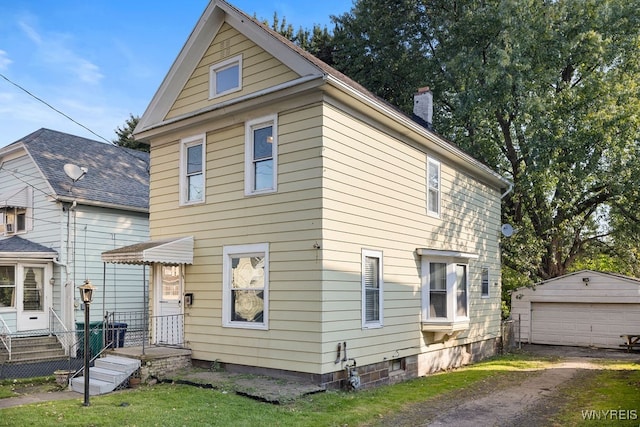 view of front of house featuring an outdoor structure and a garage