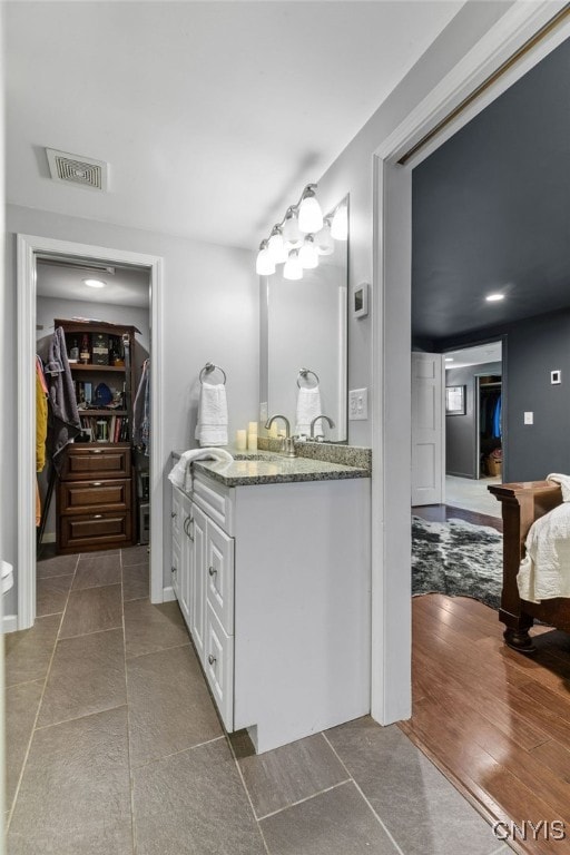 bathroom featuring hardwood / wood-style flooring and vanity