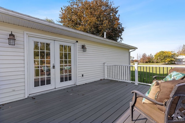 wooden deck featuring a yard