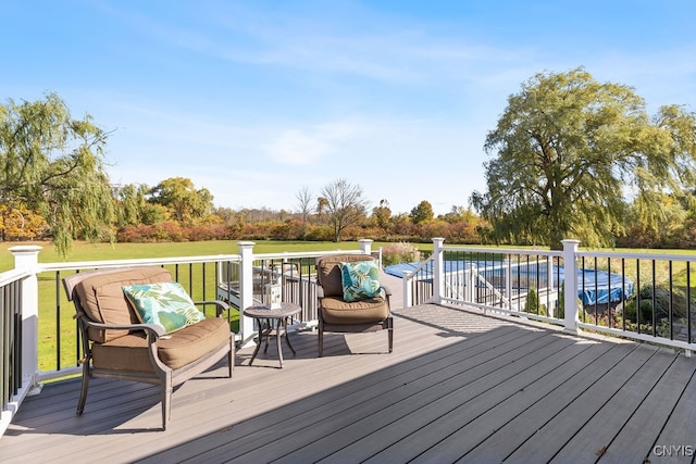 wooden terrace with a lawn