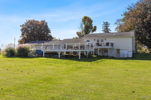 rear view of house with a yard and a deck