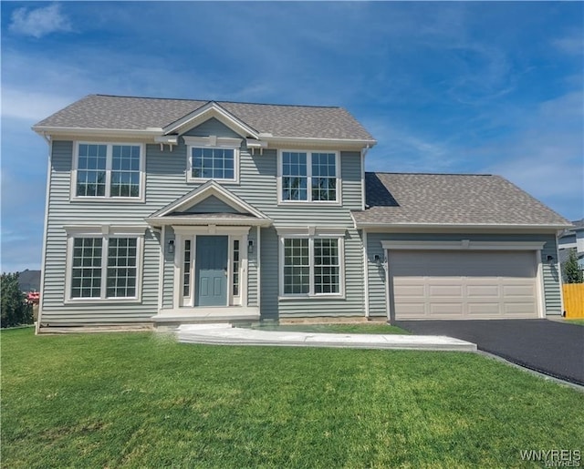 view of front facade with a garage and a front lawn