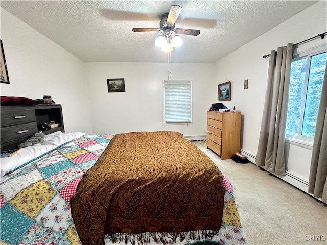 carpeted bedroom featuring ceiling fan, a baseboard heating unit, and a textured ceiling