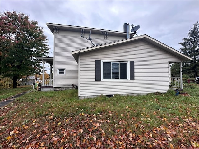 view of property exterior with a yard