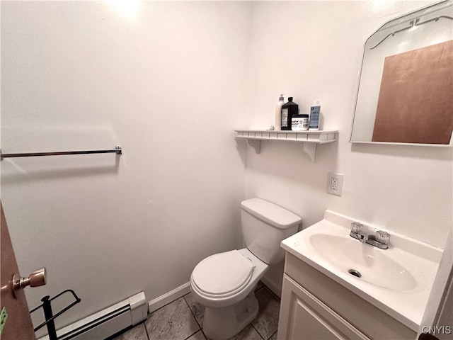 bathroom with tile patterned floors, a baseboard heating unit, vanity, and toilet