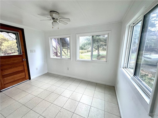 unfurnished sunroom featuring ceiling fan