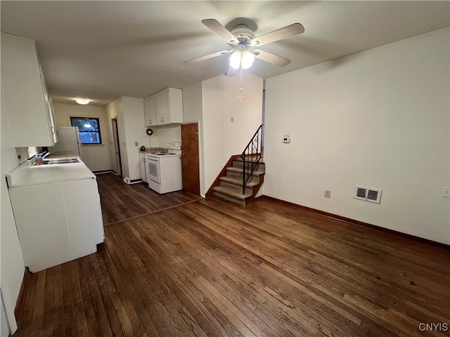 kitchen with ceiling fan, white cabinets, sink, white appliances, and dark wood-type flooring