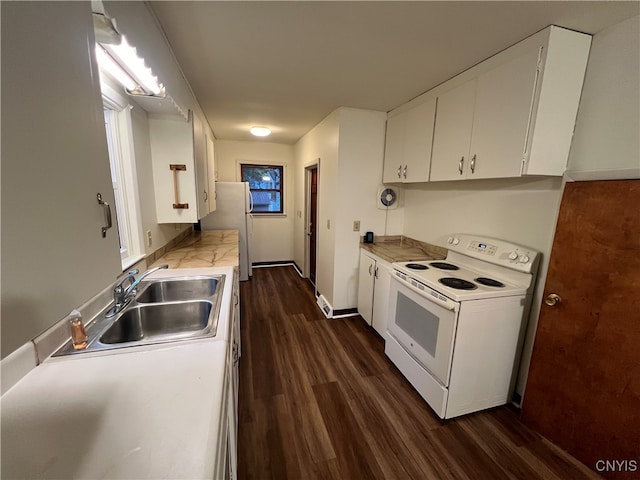 kitchen featuring white appliances, sink, dark hardwood / wood-style flooring, and white cabinetry