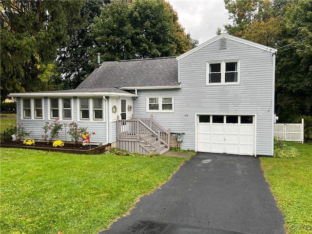 split level home featuring a front lawn and a garage