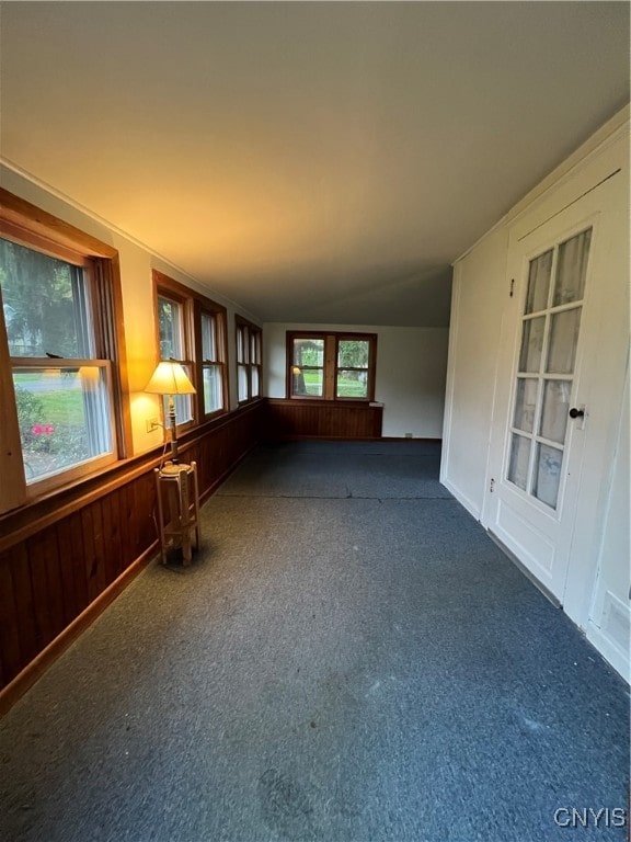 empty room with lofted ceiling and dark carpet