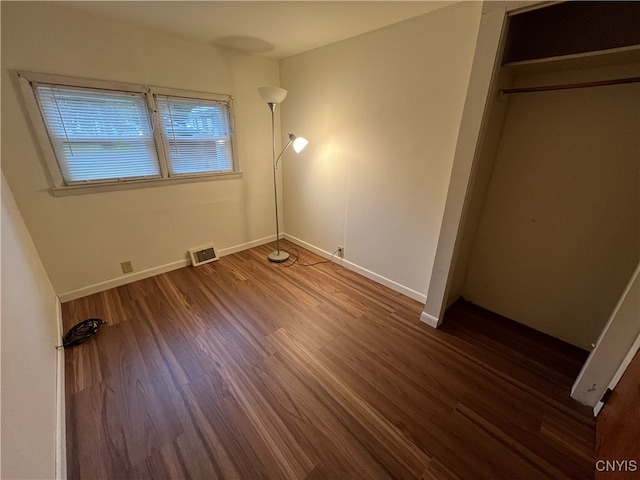 unfurnished bedroom featuring dark wood-type flooring