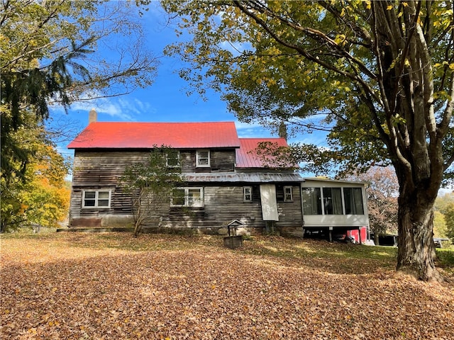 back of house with a sunroom