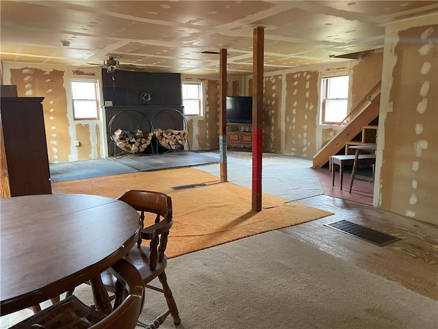 basement featuring a wealth of natural light and ceiling fan