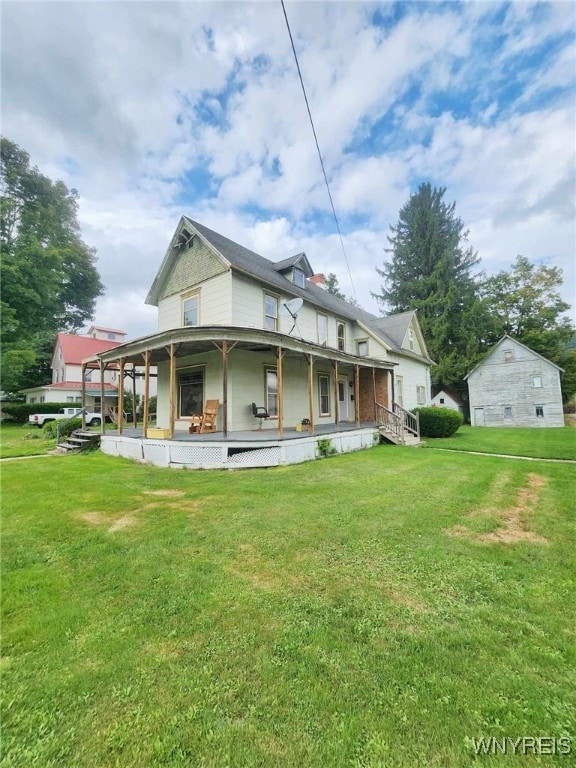 back of property featuring a yard and covered porch