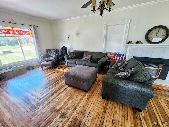 living room featuring a fireplace, ornamental molding, and hardwood / wood-style flooring