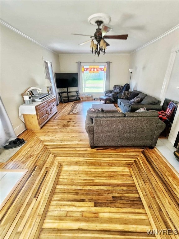 living room with ornamental molding, light hardwood / wood-style flooring, and ceiling fan