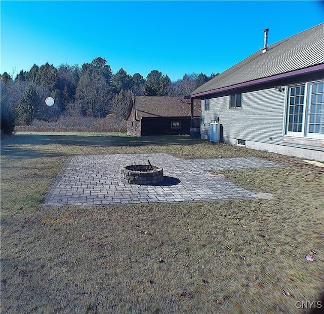 view of yard with a patio and a fire pit