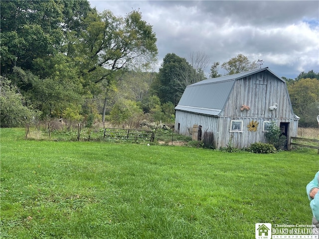 view of outbuilding with a yard