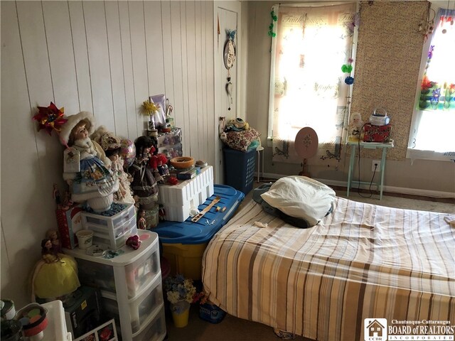 bedroom with wooden walls