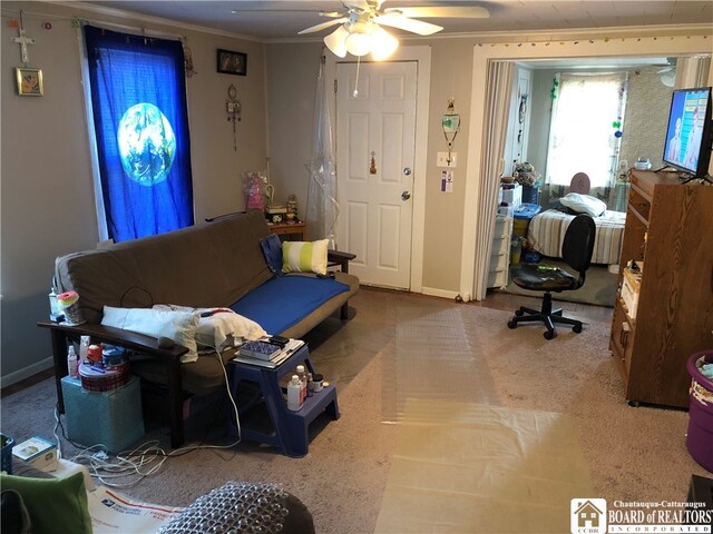 living room with carpet, ceiling fan, and ornamental molding