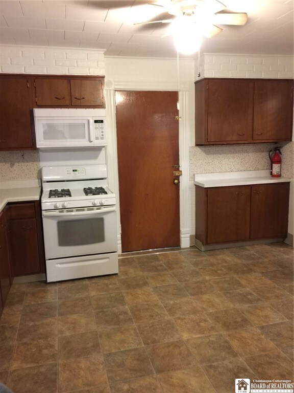 kitchen with white appliances and ceiling fan