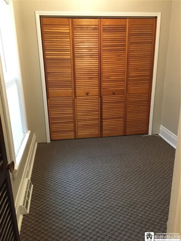 unfurnished bedroom with a closet and carpet flooring