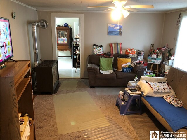 living room with ceiling fan and ornamental molding