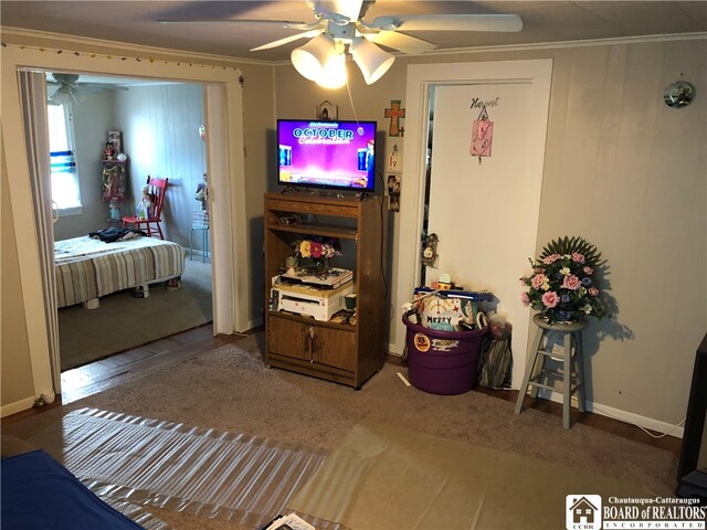 interior space with ceiling fan, crown molding, and wood-type flooring