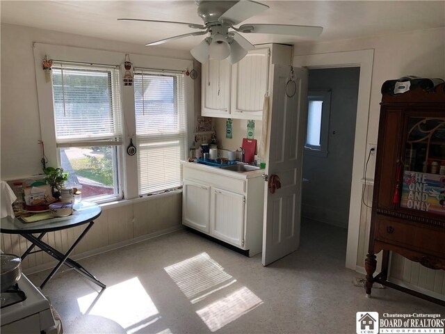 kitchen featuring white cabinets and ceiling fan