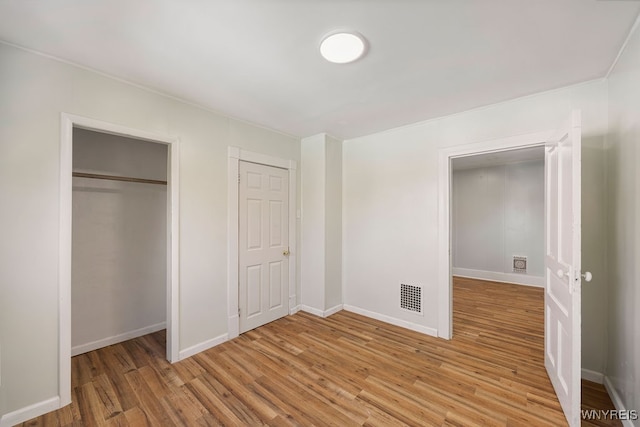 unfurnished bedroom with hardwood / wood-style floors