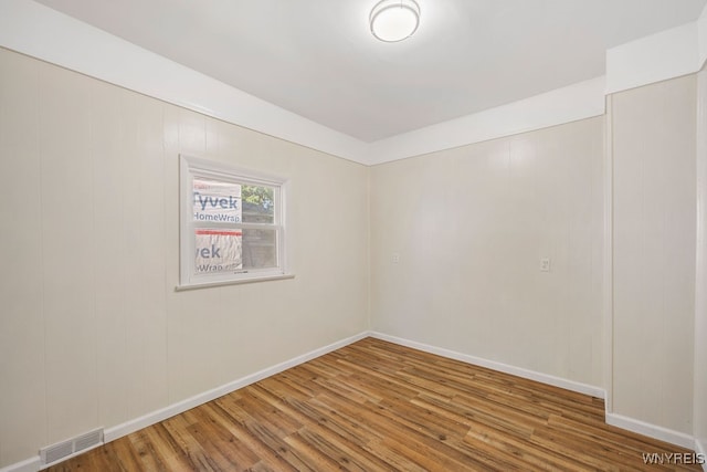 spare room with wood-type flooring