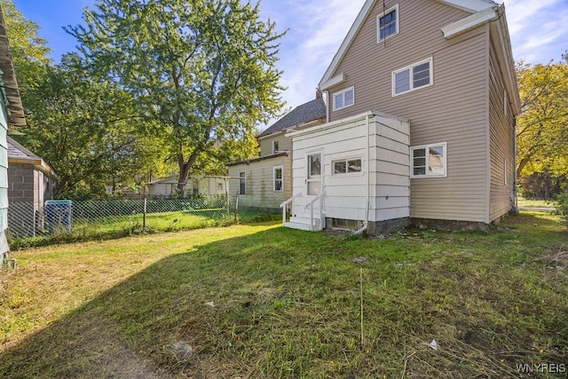 rear view of property featuring a yard