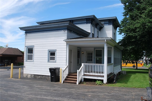 view of front of property with a front yard and covered porch