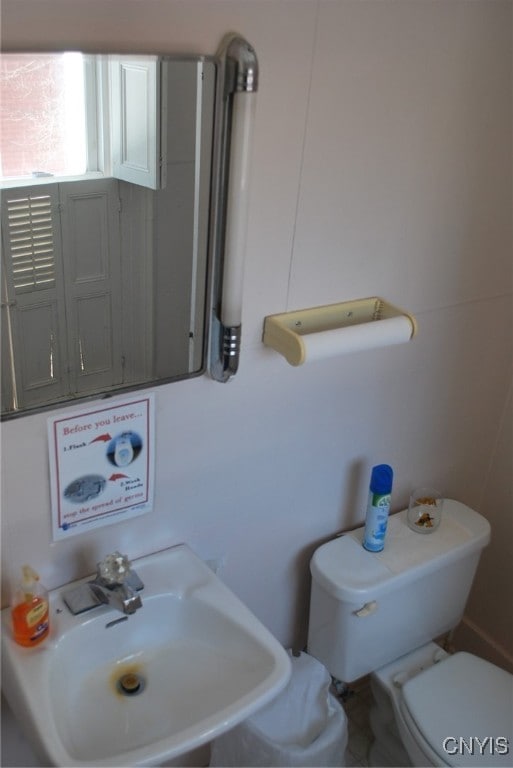 bathroom featuring sink and toilet