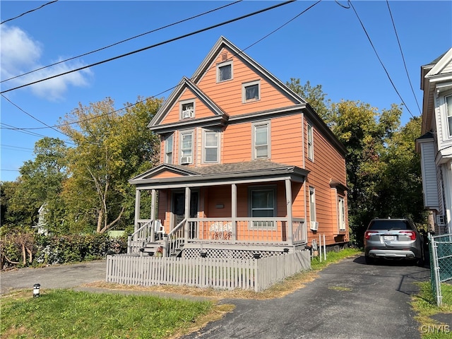 view of front of home with a porch and cooling unit