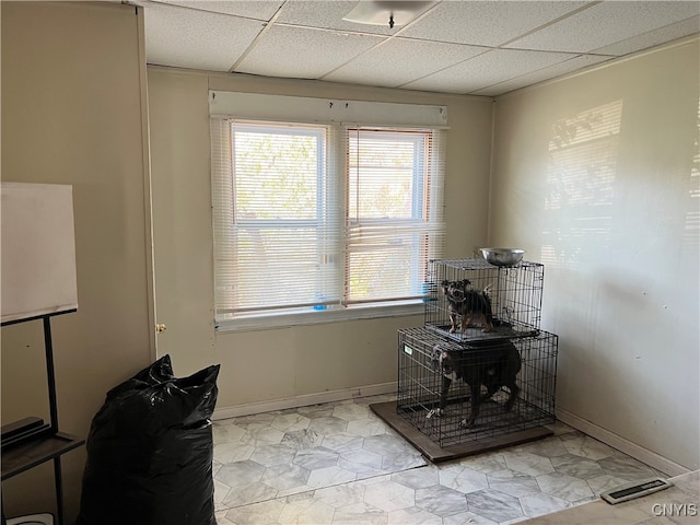 office with light tile patterned flooring and a paneled ceiling