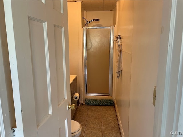 bathroom with toilet, tile patterned flooring, an enclosed shower, and vanity