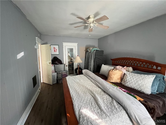 bedroom with ceiling fan and dark hardwood / wood-style floors