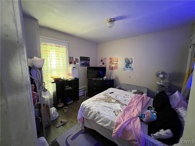 bedroom with hardwood / wood-style floors