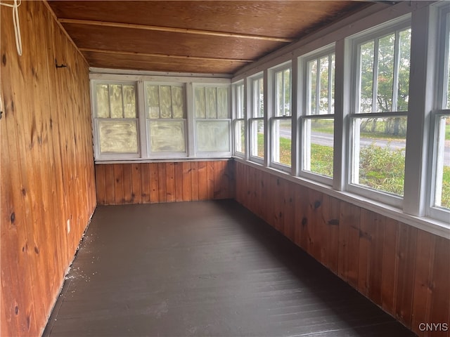 unfurnished sunroom with wood ceiling and a healthy amount of sunlight