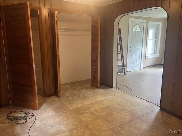 unfurnished bedroom featuring wooden walls