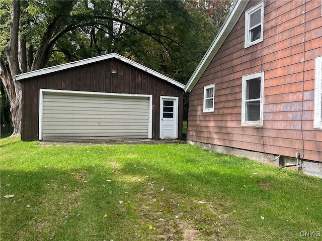 garage with wood walls and a yard