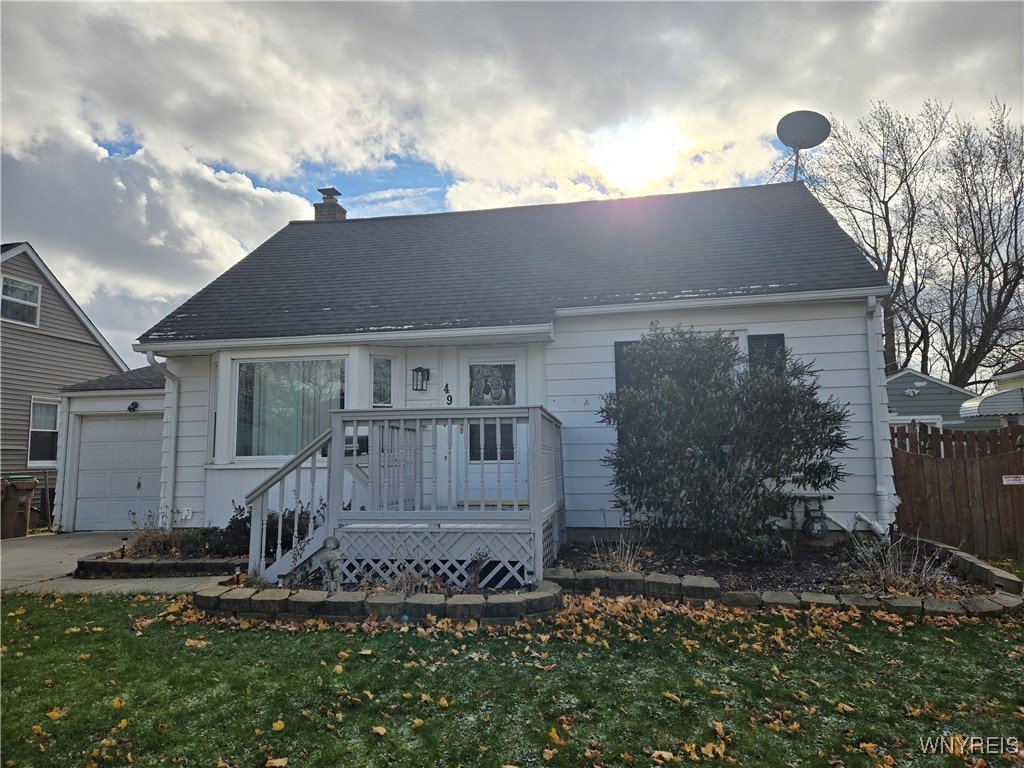 back of property featuring a yard and a garage