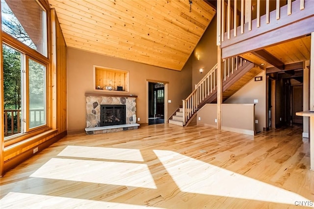 unfurnished living room featuring a fireplace, hardwood / wood-style flooring, high vaulted ceiling, and wooden ceiling